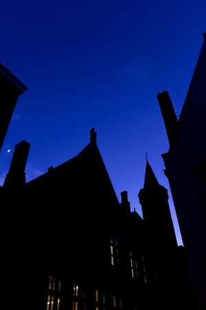 Roofs and facades in Bruges at nightの写真素材
