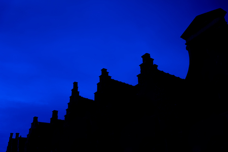 Roofs and facades in Bruges at nightの写真素材