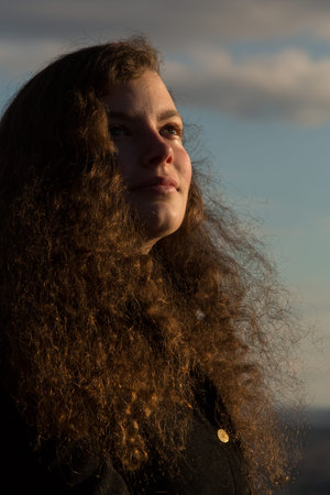 The face of a young pretty woman in the winter sun