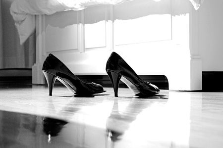 Image of high heels on bedroom floor by the bedの写真素材