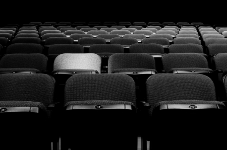 Image of many rows of seats with a spotlight on oneの写真素材