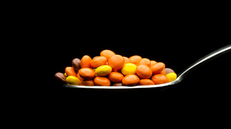 Chocolate and peanut butter candy on a spoonの写真素材