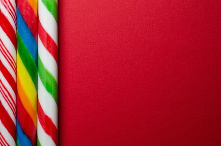Three different candy canes on redの写真素材