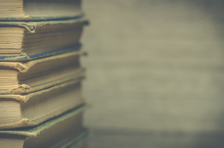 Vintage style books piled on woodの写真素材