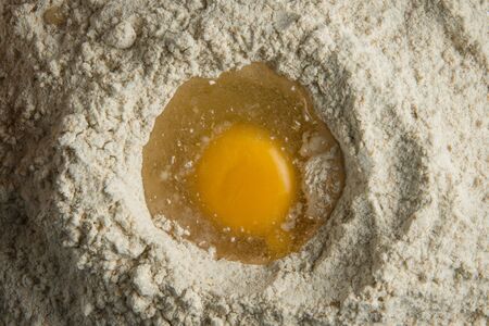 Overhead view of egg in flourの写真素材