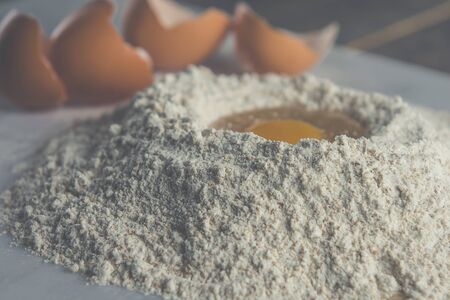 Vintage style egg in flourの写真素材