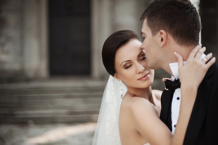 Happy bride and groom in a castle on their wedding dayの写真素材