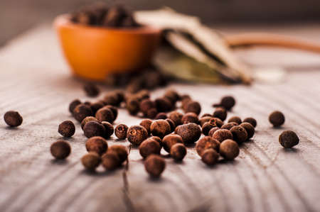 Spoon of pepper on a wooden tableの写真素材