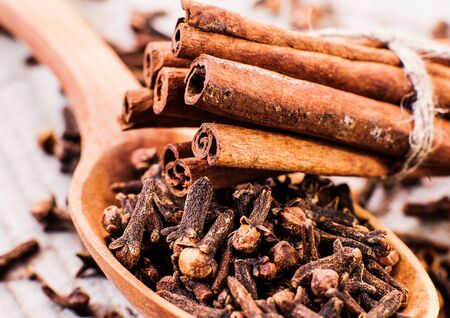 cinnamon and cloves on a wooden tableの写真素材