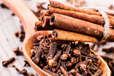 cinnamon and cloves on a wooden tableの写真素材