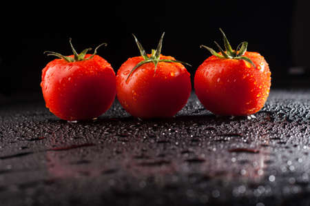 Tomato water droplets on black backgroundの写真素材