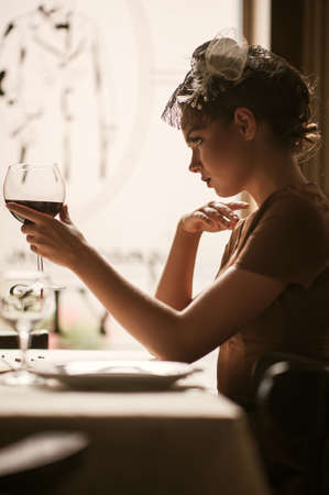 portrait of young female  drinking red wineの写真素材