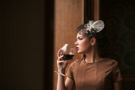 portrait of young female  drinking red wineの写真素材