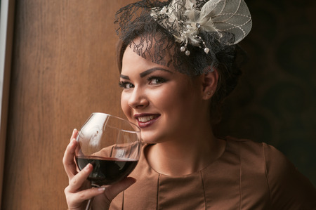 portrait of young female  drinking red wineの写真素材