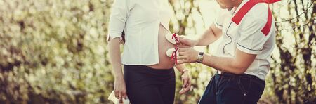 Couple waiting for baby, spring day, floweringの写真素材