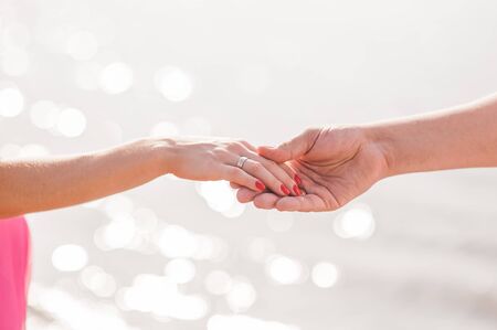Beautiful couple holding hands at sunsetの写真素材