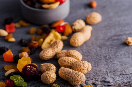 Nuts in a bowl on a wooden background. Dried fruits and nuts.A mixture of dried fruits, candied...