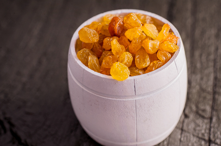 bowl of raisins. raisins on a wooden background.fresh raisinの写真素材