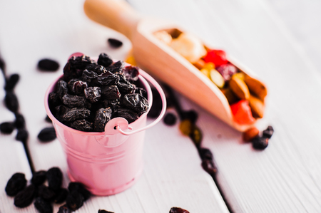 a mixture of dried fruits.raisins on a wooden backgroundの写真素材