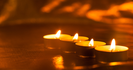 Many burning candles.Candle flame light at night の写真素材