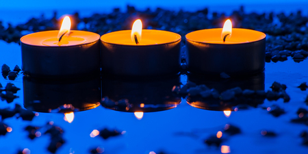 Happy Valentine's Day.Beautiful place setting for Valentine's Day.Candle  on sand with sea and sunset backgroundの写真素材