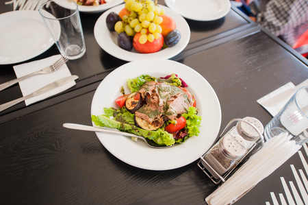    Grilled fresh-baked plates, cups, fruit.Food on the tableの写真素材