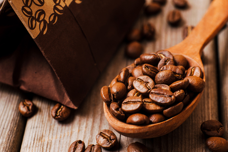 Fresh ground coffee beans on a wooden tableの写真素材