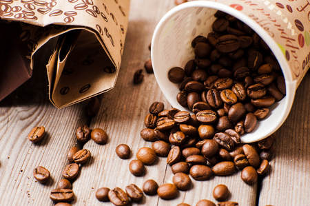 Packaging for coffee.Fresh  coffee beans on a wooden table.Glass coffeeの写真素材