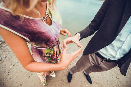 Young couple in love walking near river.Holding handsの写真素材