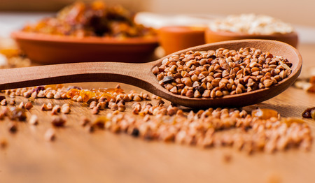     buckwheat on the table. Buckwheat seeds in spoonの写真素材