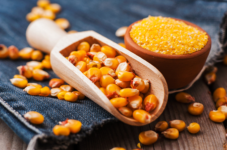 a bowl of corn is on a wooden table.Sweet cornの写真素材