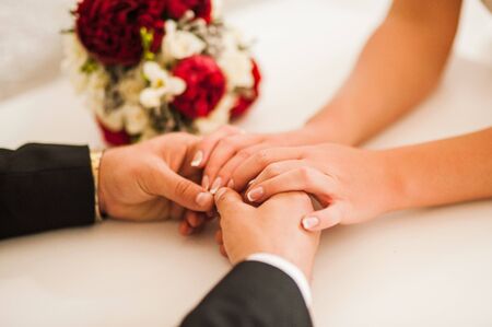 Declarations of love. Sharing RING.The groom wears gold ring brideの写真素材