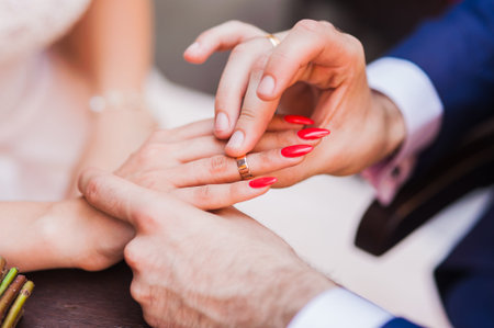 Declarations of love. Sharing RING.The groom wears gold ring brideの写真素材