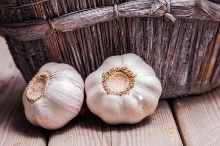 Closeup shot fresh garlic on wooden tableの写真素材