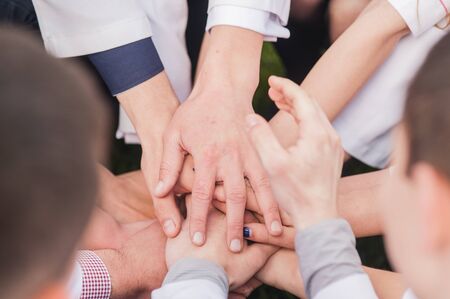 Hands of young people in the nature, team concept.Show the gestureの写真素材