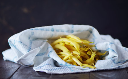 yellow beans on a wooden table background.