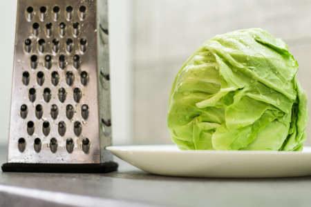 Green cabbage and grater.の写真素材