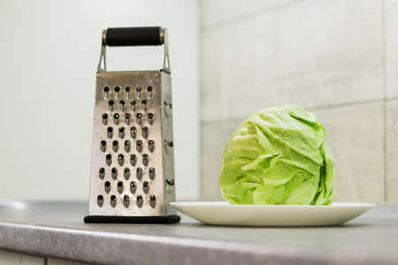 Green cabbage and grater.の写真素材