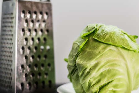 Green cabbage and grater.の写真素材