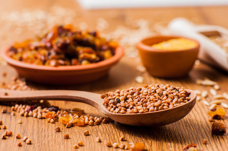 buckwheat on the table. Buckwheat seeds in spoonの写真素材