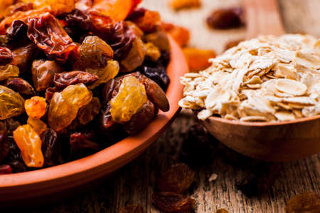 bowl of raisins. raisins on a wooden background.fresh raisinsの写真素材