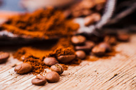 Aromatic coffee beans. preparation scrub of ground coffee. ground and whole coffee beans.coffee beans.Roasted coffee beans goals.spoon ground coffee, sugar cubesの写真素材