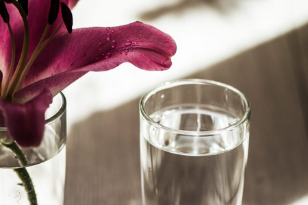 Glass of water on the table water droplets, power energy.