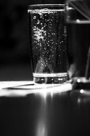 Glass of water on the table water droplets, power energy.の写真素材