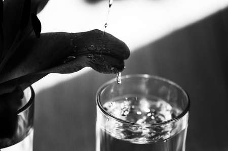 Glass of water on the table water droplets, power energy.の写真素材