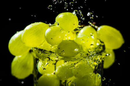 Green grapes in water. Water drops spray.の写真素材