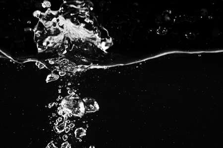 Water splash with bubbles on a black background. Black and white.の写真素材
