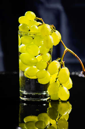 Green grapes in water. Water drops spray.の写真素材