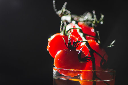 Fruit delicious cherry tomatoes in water. Water drops splashes.