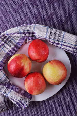 Delicious nectarines on the table. Vitamins are useful.